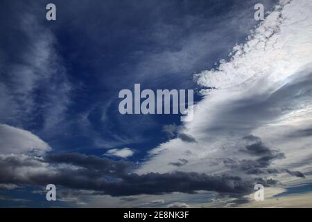 Sky with different types of clouds including a band of so called mackerel sky, indicator of a weather change Stock Photo