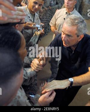 US service members gather around President George W. Bush, who shakes numerous hands, during his surprise visit to Al Asad Air Base, Iraq on September 3, 2007. Bush was joined by Secretary of Defense Robert Gates, Secretary of State Condolezza Rice, Chairman of the Joint Chiefs of Staff Gen. Peter Pace and others. Photo by DOD via ABACAPRESS.COM Stock Photo