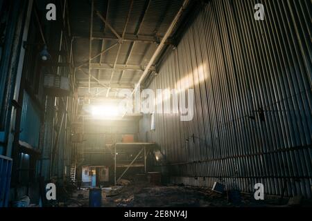 Large creepy industrial warehouse inside view of abandoned factory. Stock Photo