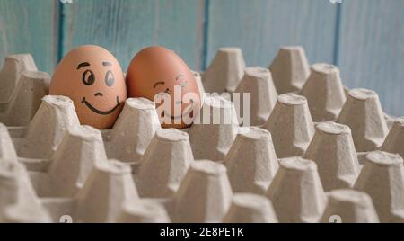 Faces painted on two eggs. Concept for love romance, valentine's day. Stock Photo