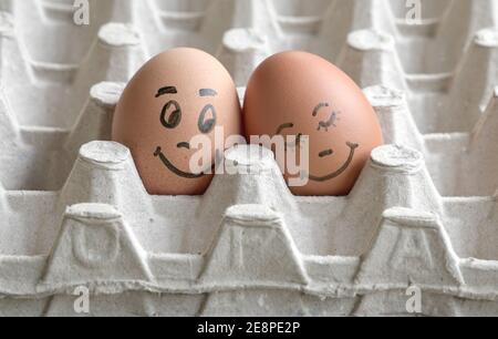 Faces painted on two eggs. Concept for love romance, valentine's day. Stock Photo