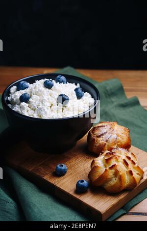 Cottage Cheese In Bowl. Homemade Curd Cheese Served With currant berries or blueberry. Healthy breakfast concept. Stock Photo