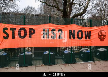 London, UK. 31 Jan 2021. HS2 Rebellion activists displayed the 'Stop HS2 Now' banner on the fence in Euston Square Gardens. Credit: Waldemar Sikora Stock Photo