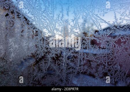 Frozen glass. Frost patterns on window pane. Stock Photo