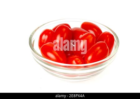 Small red oval cocktail cherry tomatoes on white background. Photo Stock Photo