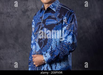 portrait of a man wearing a government service batik. clothes with blue batik motifs. government shirts for formal events Stock Photo