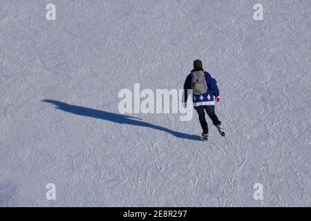 View from above of skater with his long shadow on the Rideau Canal Skateway in Ottawa on a brisk sunny winter' Stock Photo