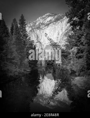 Cliff reflects in still river at Yosemite Stock Photo