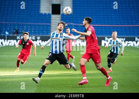 Cornella, Spain. 31st Jan, 2021. Espanyol's Javi Puado (L, front) vies with Vallecano's Alejandro Catena during a Spanish second division league match between RCD Espanyol and Rayo Vallecano in Cornella, Spain, on Jan. 31, 2021. Credit: Joan Gosa/Xinhua/Alamy Live News Stock Photo