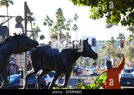 A man taking selfie next to the horse sculpture in Old Town Scottsdale, Phoenix, Arizona Stock Photo