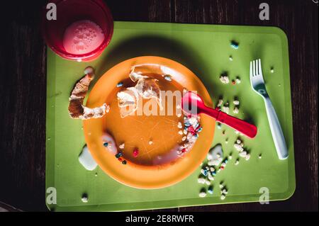 Children can be messy eaters - typical arrangement after eating. Stock Photo