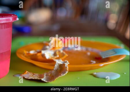 Children can be messy eaters - typical arrangement after eating. Stock Photo