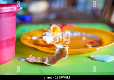 Children can be messy eaters - typical arrangement after eating. Stock Photo