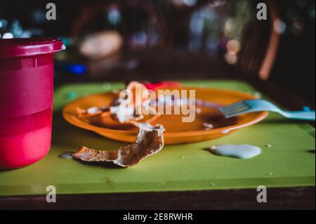 Children can be messy eaters - typical arrangement after eating. Stock Photo