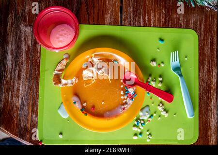 Children can be messy eaters - typical arrangement after eating. Stock Photo