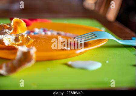 Children can be messy eaters - typical arrangement after eating. Stock Photo