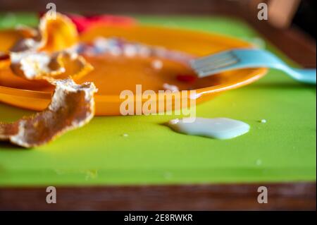 Children can be messy eaters - typical arrangement after eating. Stock Photo