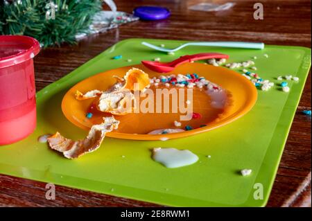 Children can be messy eaters - typical arrangement after eating. Stock Photo