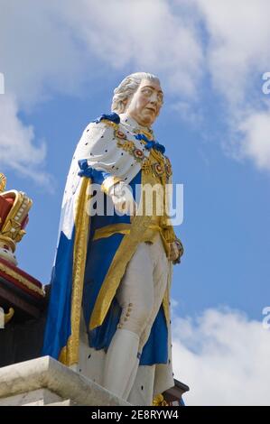 Colourful statue of King George III overlooking the esplanade at the seaside resort of Weymouth, Dorset. Statue erected in 1810 to mark the monarch's Stock Photo