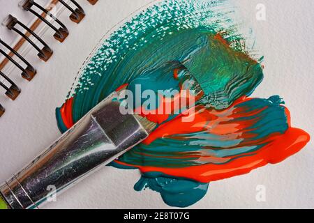 Brush when mixing paint on paper, macro shot Stock Photo
