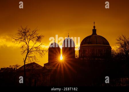 Rays of the sun at sunset make their way through the domes of Cathedral. The pro-Kafedral Catholic Cathedral of St. Alexander in Kiev. Stock Photo