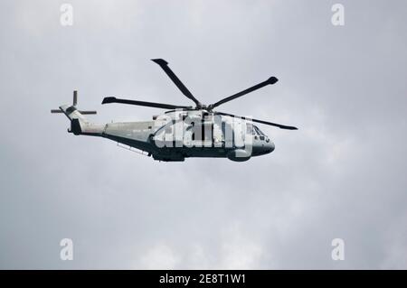 PORTLAND, DORSET, ENGLAND - AUGUST 31: Royal Navy Merlin helicopter flying over Portland Harbour on August 31 2012. The Royal Navy is protecting event Stock Photo