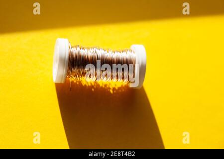 copper wire on small plastic spool Stock Photo