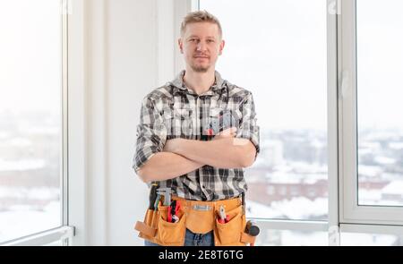 Young caucasian worker with tool belt Stock Photo