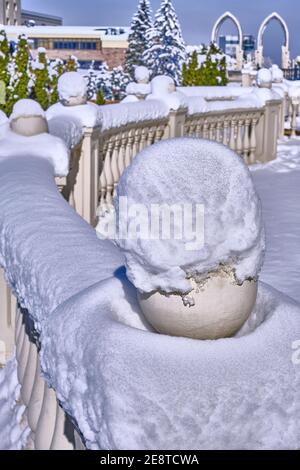 Freshly fallen snow on the decorative railing in the winter season; modern architectural forms Stock Photo
