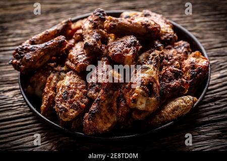 Chicken wings barbeque in a cast iron baking dish Stock Photo