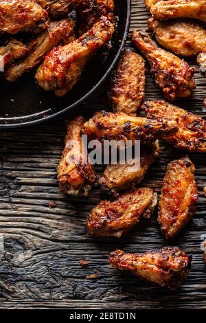 Chicken wings barbeque in a cast iron baking dish - Top of view Stock Photo