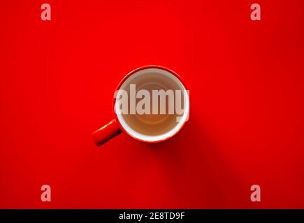 Flat lay of empty red coffee cup on red background Stock Photo