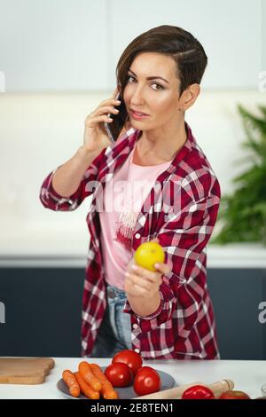 Woman Is Talking By Phone About New Recipe Stock Photo - Alamy