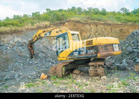 Bulldozer equip with drill, breaking down a hill landscape for homes and buildings. Stock Photo