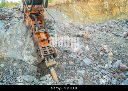 Bulldozer equip with drill, breaking down a hill landscape for homes and buildings. Stock Photo