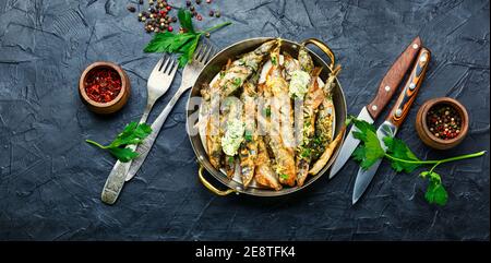 Fried capelin fish with herbs and lemon zest Stock Photo