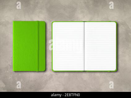 Green closed and open lined notebooks mockup isolated on concrete background Stock Photo