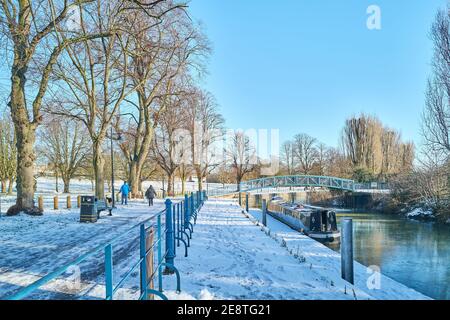 A couple exercise by the river Nene in Beckets Park, Northampton, England, in january 2021 during the national lockdown to combat covid-19. Stock Photo