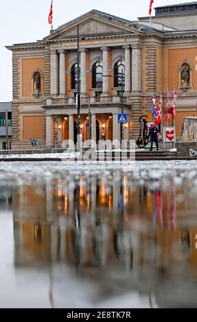 01 February 2021, Saxony-Anhalt, Halle (Saale): The Opera House, currently closed due to Corona, is reflected in a sheet of ice. Restrictions on public life remain in place throughout the country to contain the Corona pandemic. Photo: Hendrik Schmidt/dpa-Zentralbild/dpa Stock Photo
