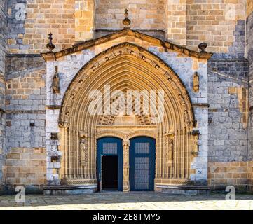 Entrance door and main facade of old stone church of Andra Maria in Guernica, Basque Country, Spain. Archway to medieval cathedral. Stock Photo