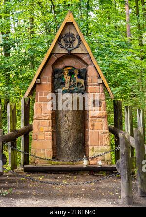 Zagnansk, Poland - August 23, 2020: Traditional wooden shrine besides Bartek Oak nature monument in Swietokrzyskie Mountains village Zagnansk Stock Photo