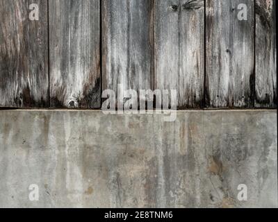 Old wood plank and concrete wall texture background. Dark brown wood plank surface with cement background. Stock Photo
