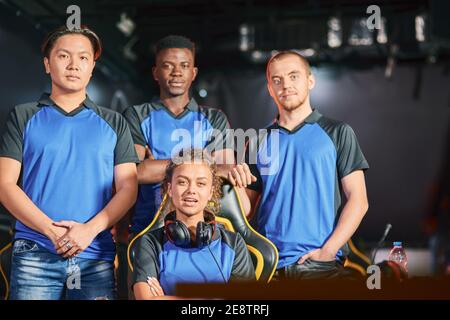 Champions. Group of multiracial cybersport gamers looking at camera, participating in eSport tournament. Online video games competition Stock Photo