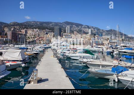 Monaco principality cityscape, pier with boats and yachts at Port Hercule in the Mediterranean Sea, view to Monte Carlo Stock Photo