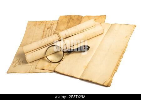 Magnifying glass with old sheets isolated on white background Stock Photo