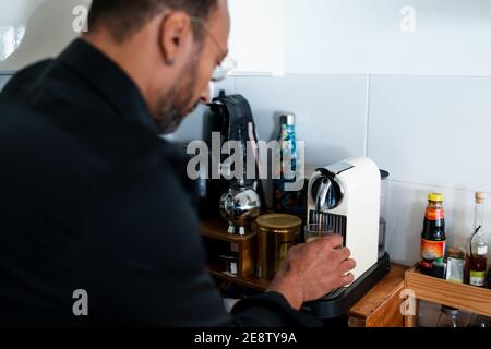 Handsome man making coffee at home Stock Photo