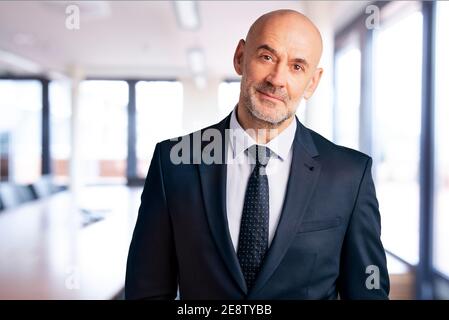 Portrait shot of financial advisor businessman standing in the office. Stock Photo