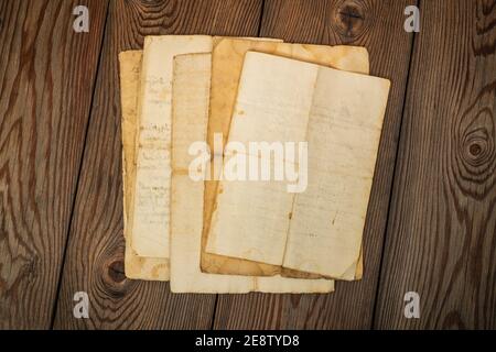 Old sheets stacked on wood background Stock Photo