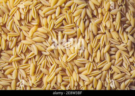 Italian pasta concept. Uncooked raw Italian gnocchetti pasta background. Stock Photo