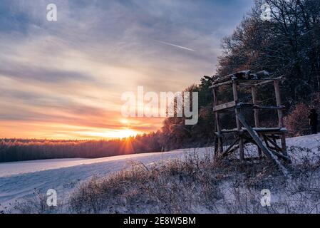 high seat in a winter landscape at the edge of the forest in the sunset. In a  winter wonderland. Stock Photo